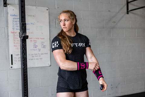 female athlete wearing pink sweatbands