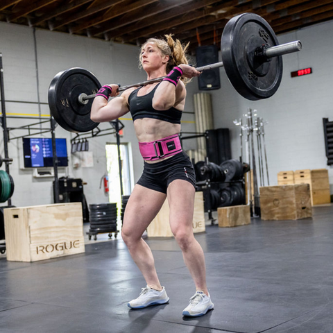 female athlete lifting weights in pink belt