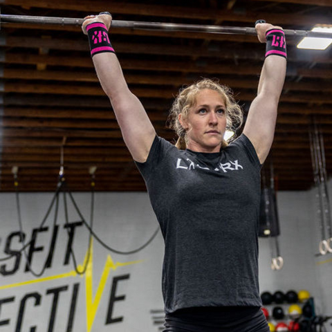 female athlete warming up with barbell