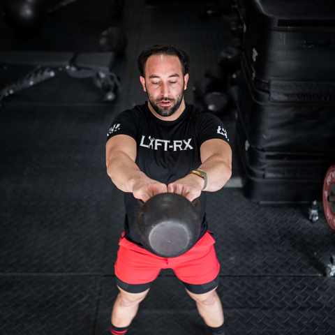 male athlete lifting kettlebell