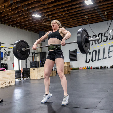 female athlete wearing belt lifting weights