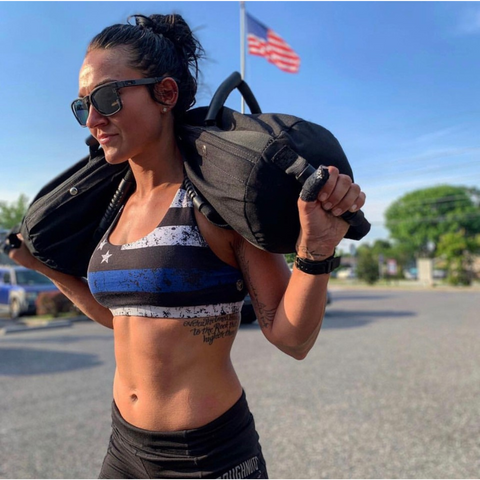 female athlete carrying weights