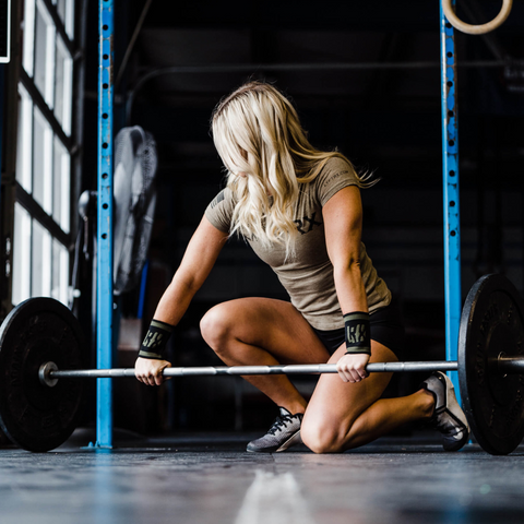 female athlete folding weights