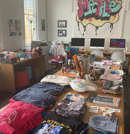 Tables lined with gifted items at the Alice House party are shown. 