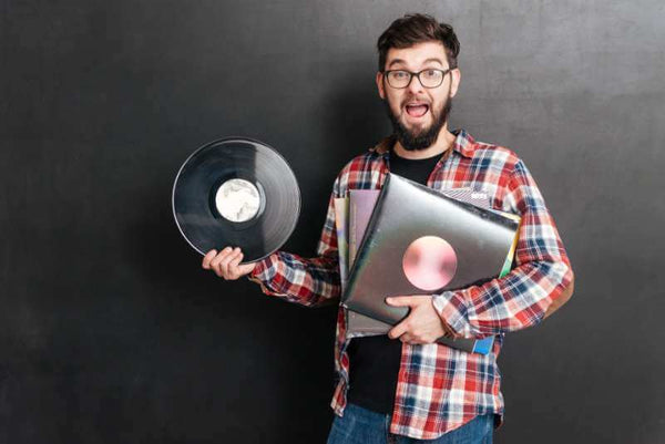 A man showing you the common vinyl record storage mistakes to avoid