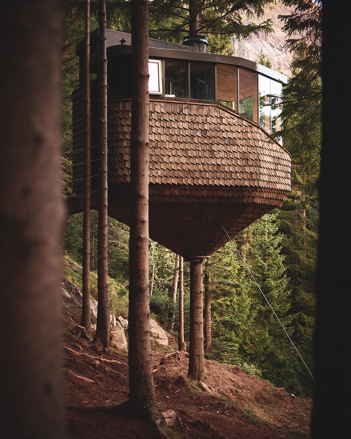 Image of WOODNEST, a treehouse found in Odda, Norway. The design is reminiscent of a pinecone.