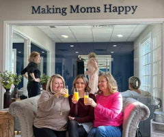 Happy moms toasting at The Queen's Lace