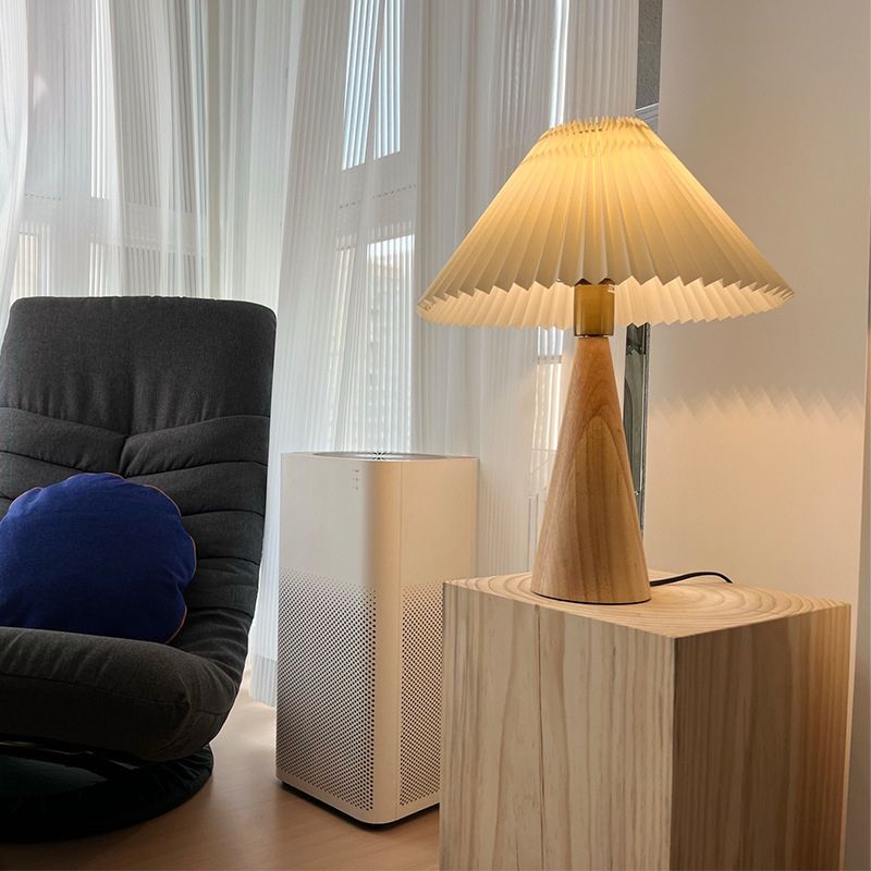 lampe de chevet design bois moerne allumée dans un salon sur une table
