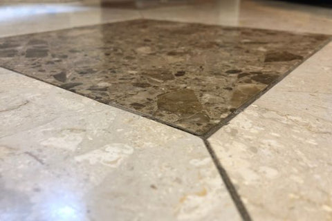 Aged granite tile floor in a hotel lobby prior to grinding and polishing