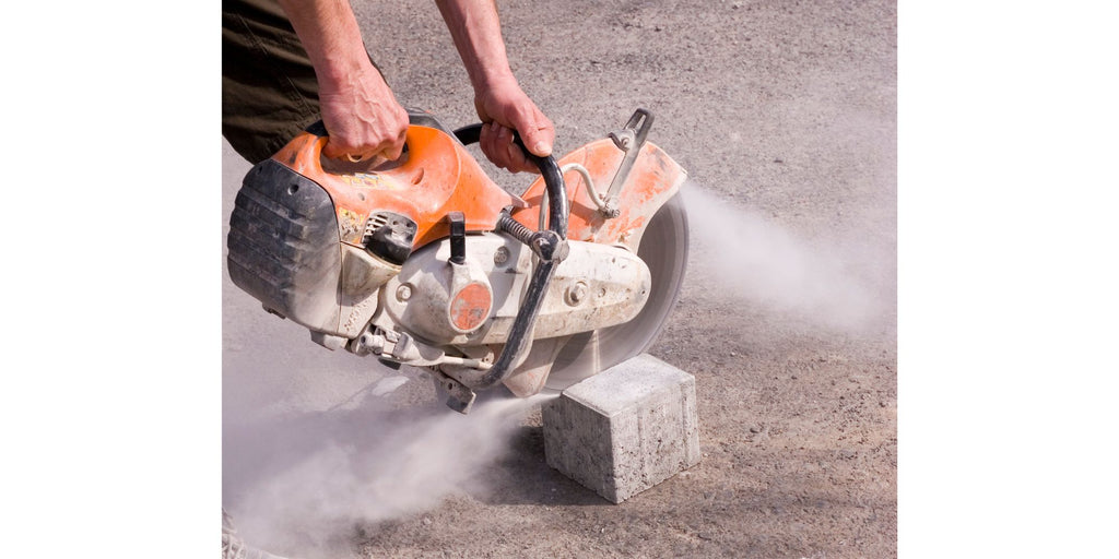 Banner Blog Post Cutting Paving Stones - Craftsman with a great flex cutting a paving stone