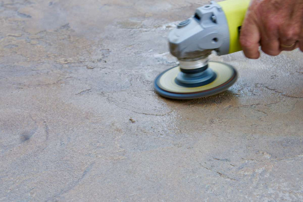 The concrete base of an angle grinder is ground