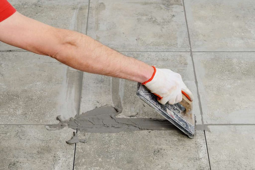 Tiles are grouted after laying on the balcony