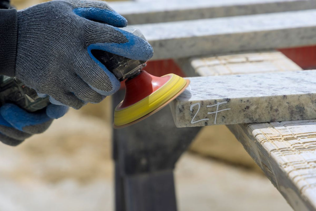 Do-it-yourselfers polishing granite slabs with angle grinders and diamond polishing discs in several steps and grits