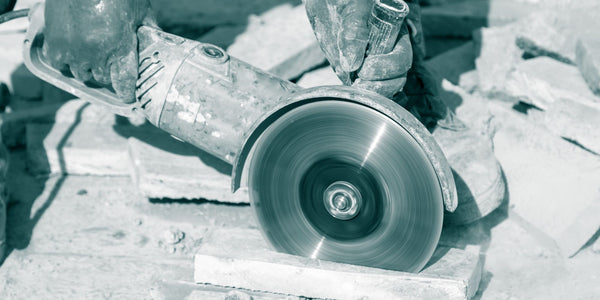 Craftsmen cutting paving slabs with a large flex