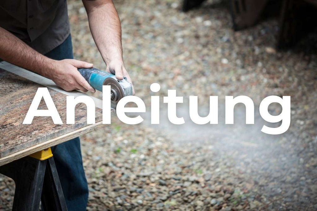 A do-it-yourselfer cutting granite with an angle grinder and a 125 mm granite diamond cutting disc