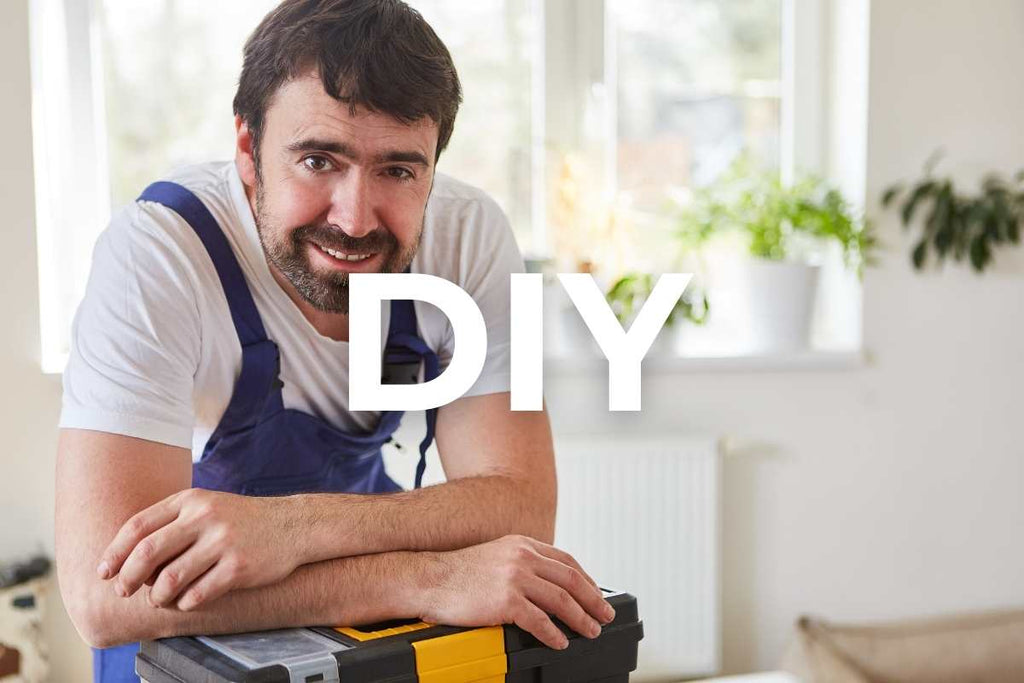 A picture of a handyman taking a break from laying natural stone after cutting