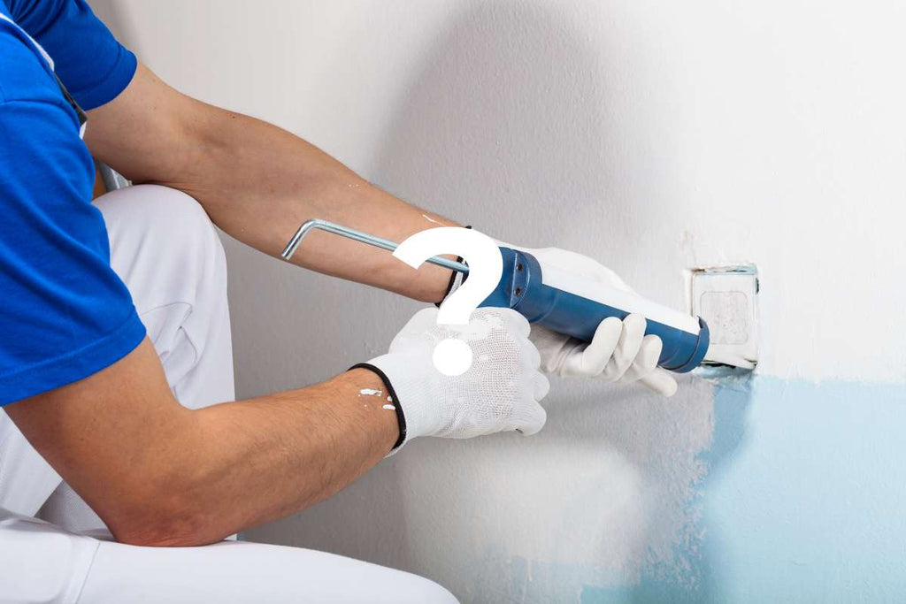 Image of a tiler using a squeezing gun to seal an opening with silicone