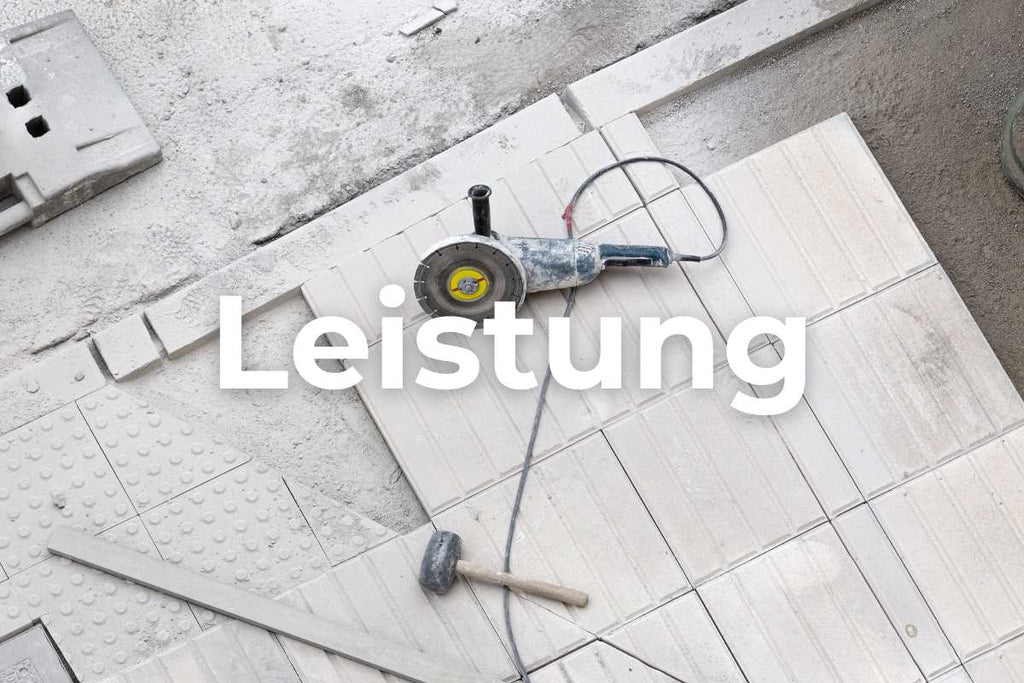 An image of a powerful angle grinder placed on a porcelain tile after cutting. The tool that is fitted is a 125mm flex diamond disc for porcelain stoneware