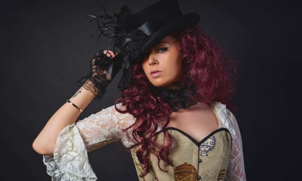 steampunk woman with purple hair wearing a hat