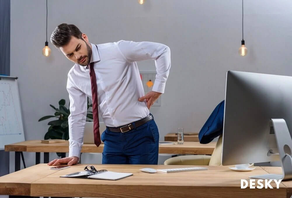 Back pain distracts businessman in the office