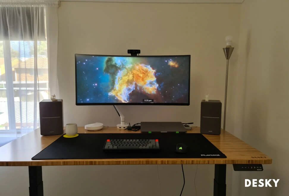 monitor mounted on a standing desk