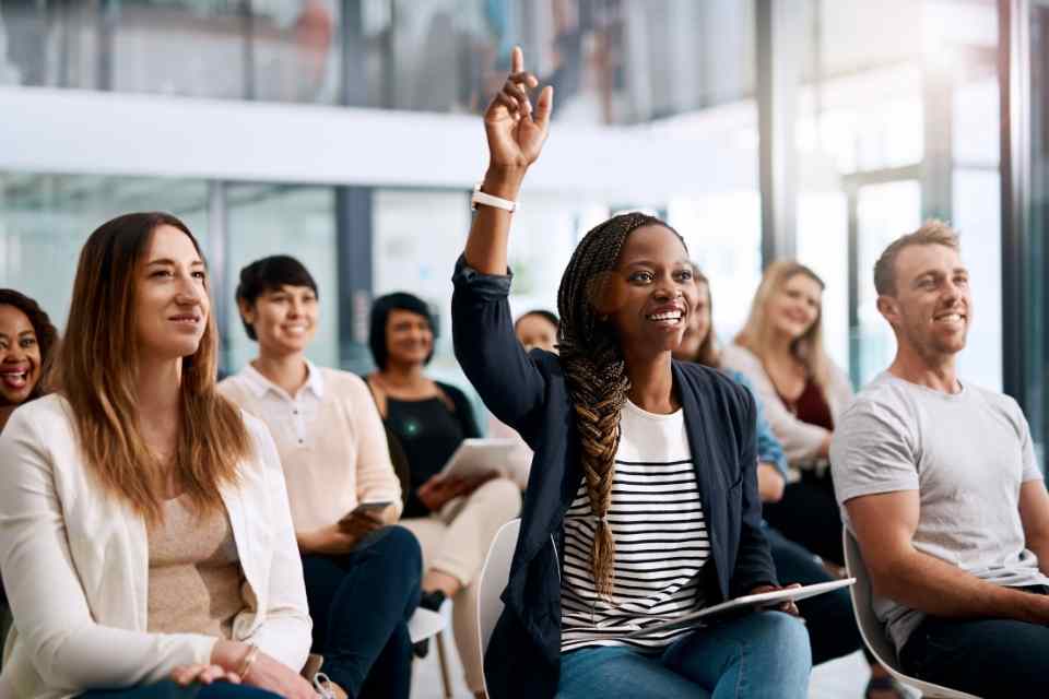 Image of a group of community members in a community meeting engaging in their community