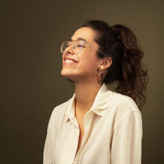 Alex Fine of Dame products in profile wearing glasses and smiling