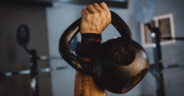 Kettlebell being hoisted by athlete for full body workout