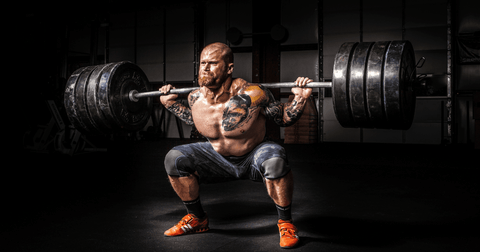 Man using progressive overload training squat