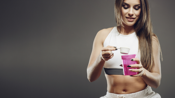 Fitness athlete adding intraworkout to her blender bottle.