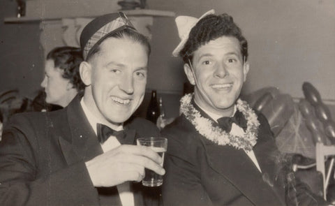 two men wearing suits at party