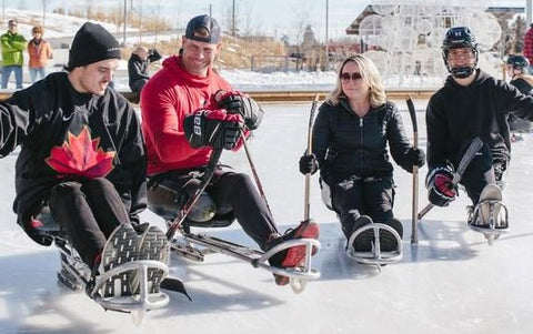 Photo of people of Sledge Hockey sledges on ice skating rink.