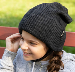 Young girl wearing seizure helmet that looks like a winter hat