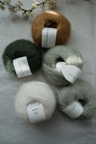 Assorted balls of KFO Silk Mohair, displayed on a neutral background.