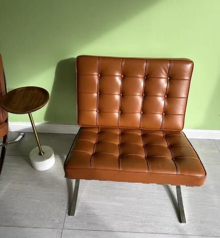 brown barcelona chair and ottoman