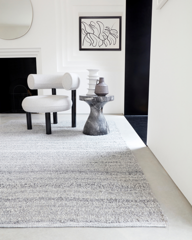 A Minimaluxe room with elements of Minimalism and luxury. The design is simple but still inviting. The chair has soft round edges and has a clear texture to it. The table is also rounded but has a marbled effect that stops the room from becoming to minimlastic. The large grey rug pulls the room together and adds the to the Minimaluxe design. The room is calming and not over-whelming.