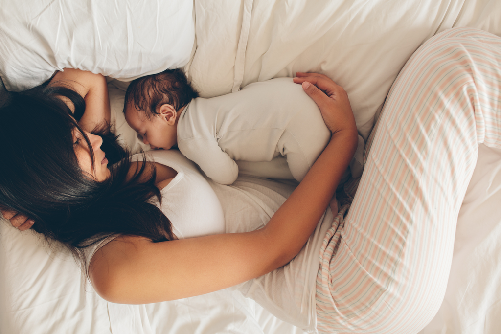 postpartum mom in bed with baby