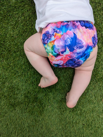 Baby bum in an abstract rainbow nappy