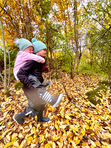 Susanna Ylinen's children are playing in a backpack and the wonderful shoes are clearly visible.