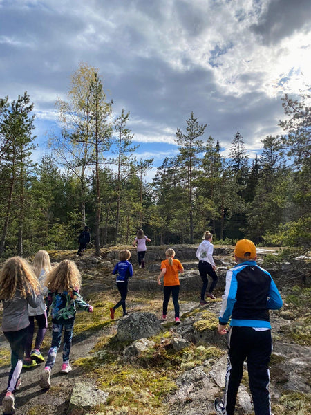 Children run up the cliff