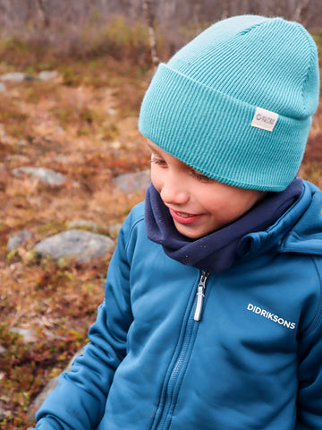 a child outside wearing a beanie
