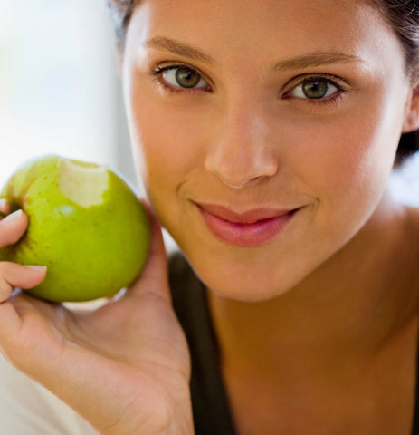 Woman holding green apple