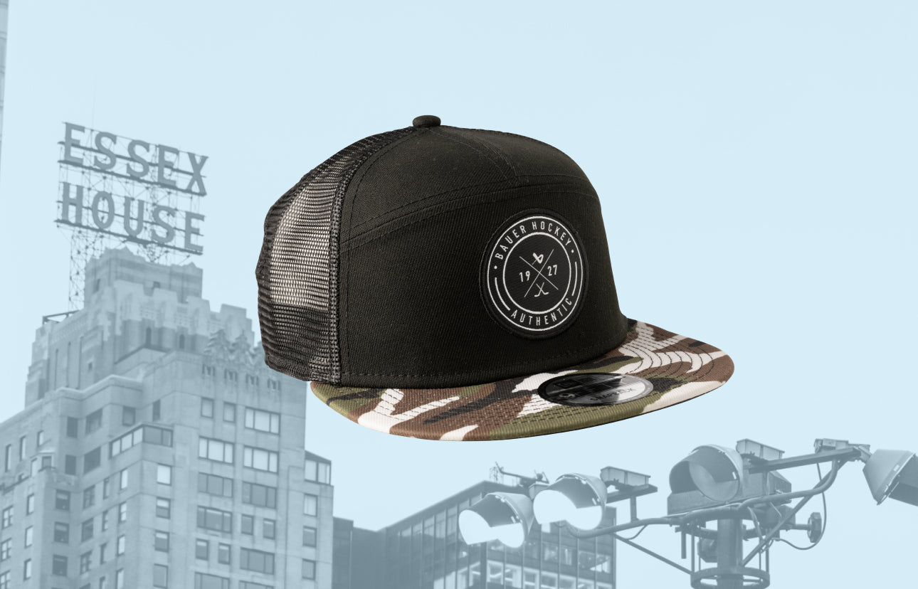 a baseball cap with a background of the nyc skyline