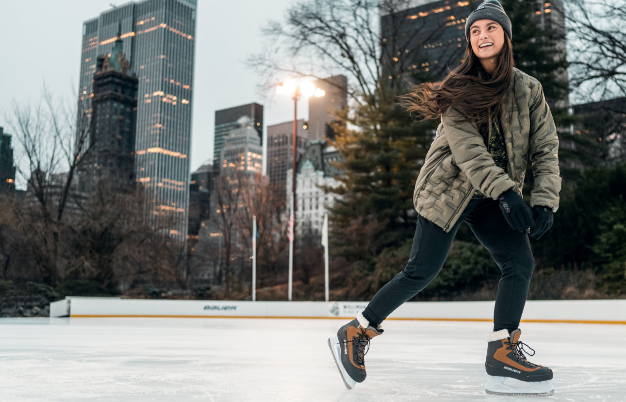 Woman skating and smiling on outdoor ice rink