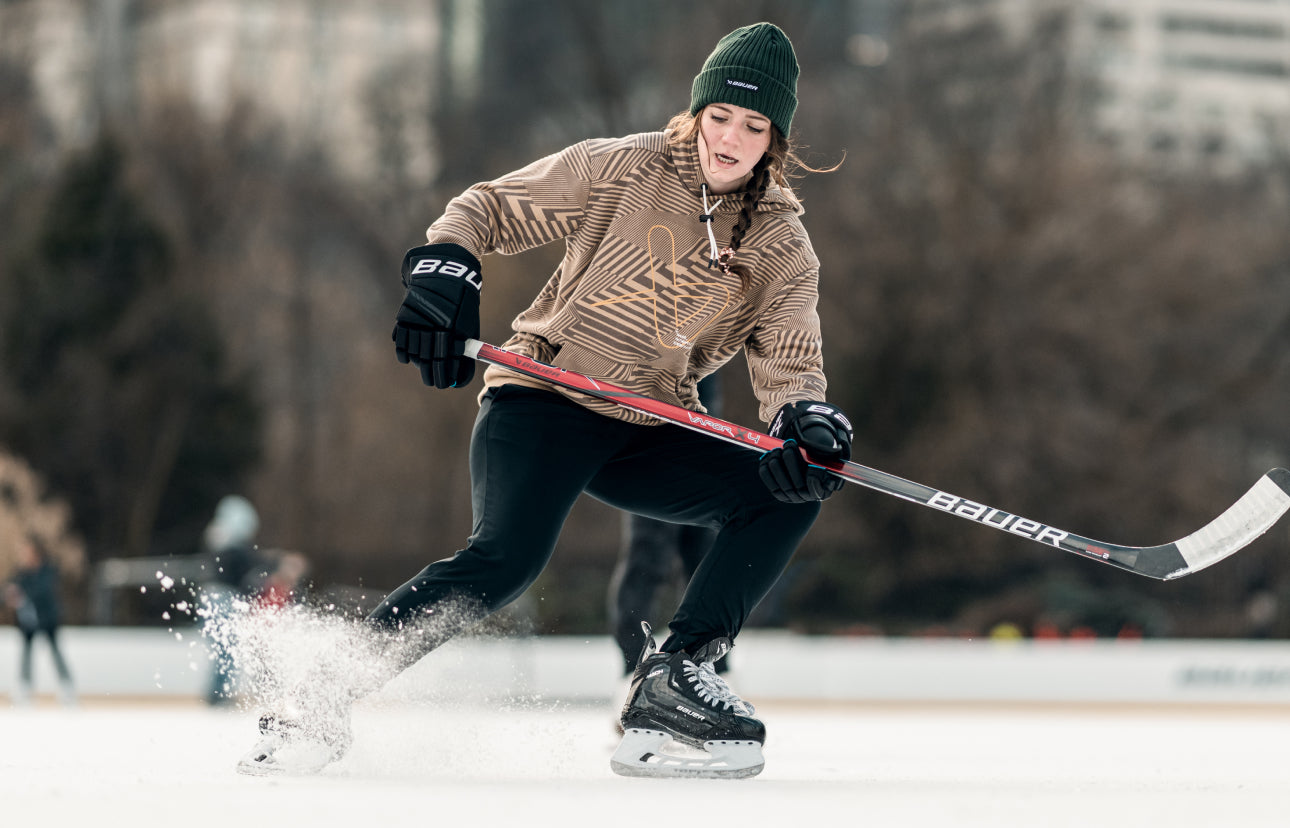 Woman playing hockey on a frozen outdoor ice rink