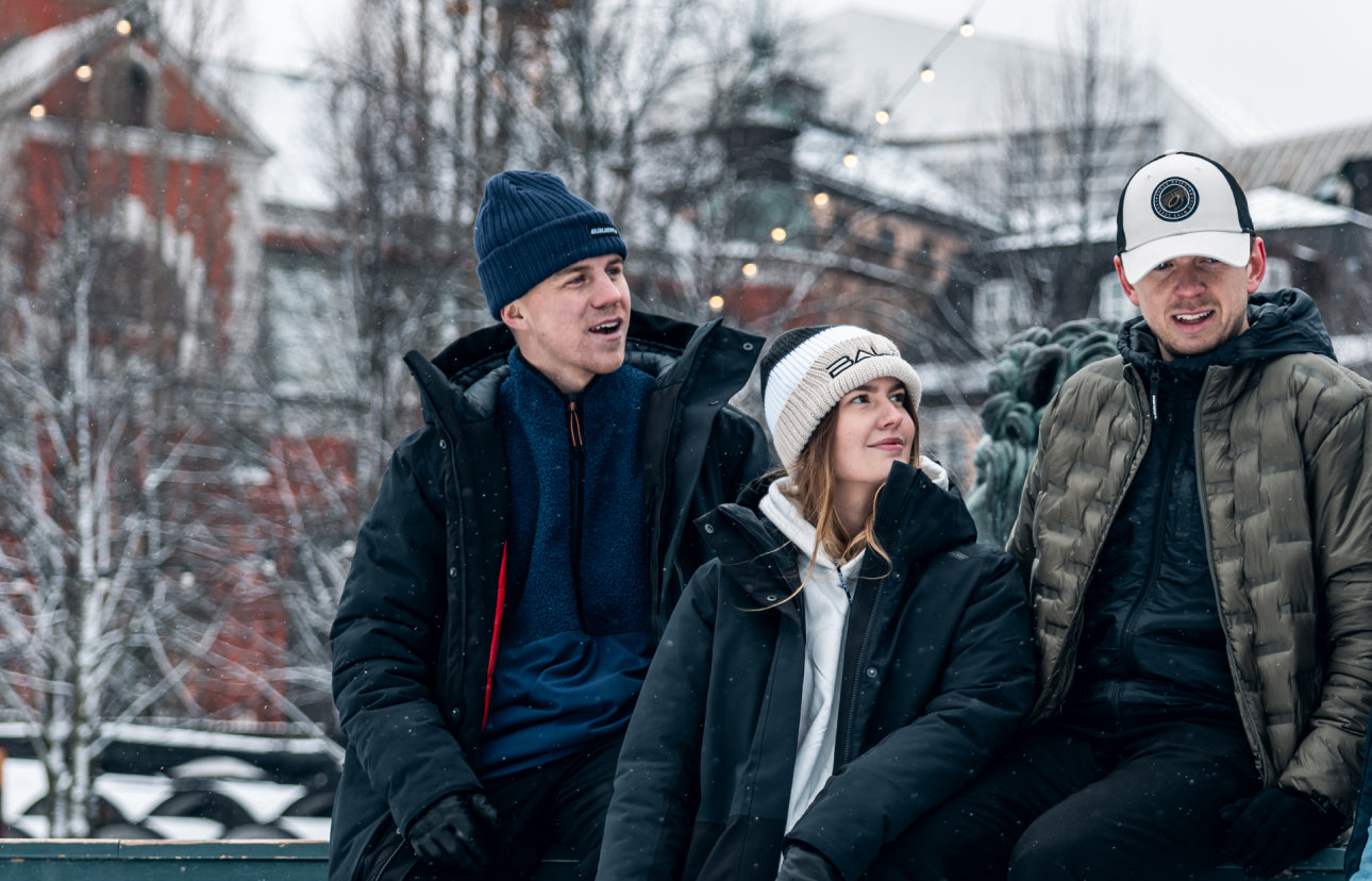 group of people standing outside and talking in a winter city scene