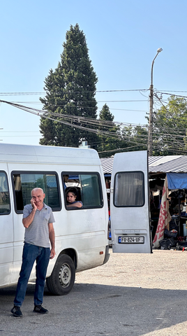 Man calling at bus station