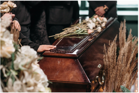 putting hand on the coffin