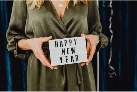 woman holding happy new year sign