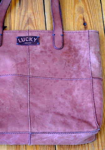 water-stained leather bag